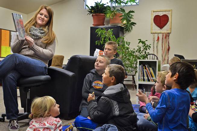 Michael-Ann Lazzarino shows children a book in the children's book nook in Virginia City in 2013. Lazzarino is the elementary programs director of Community Chest, a nonprofit group that opened the book nook last year  in its community center.  The Storey County Public Library closed in 2012.
